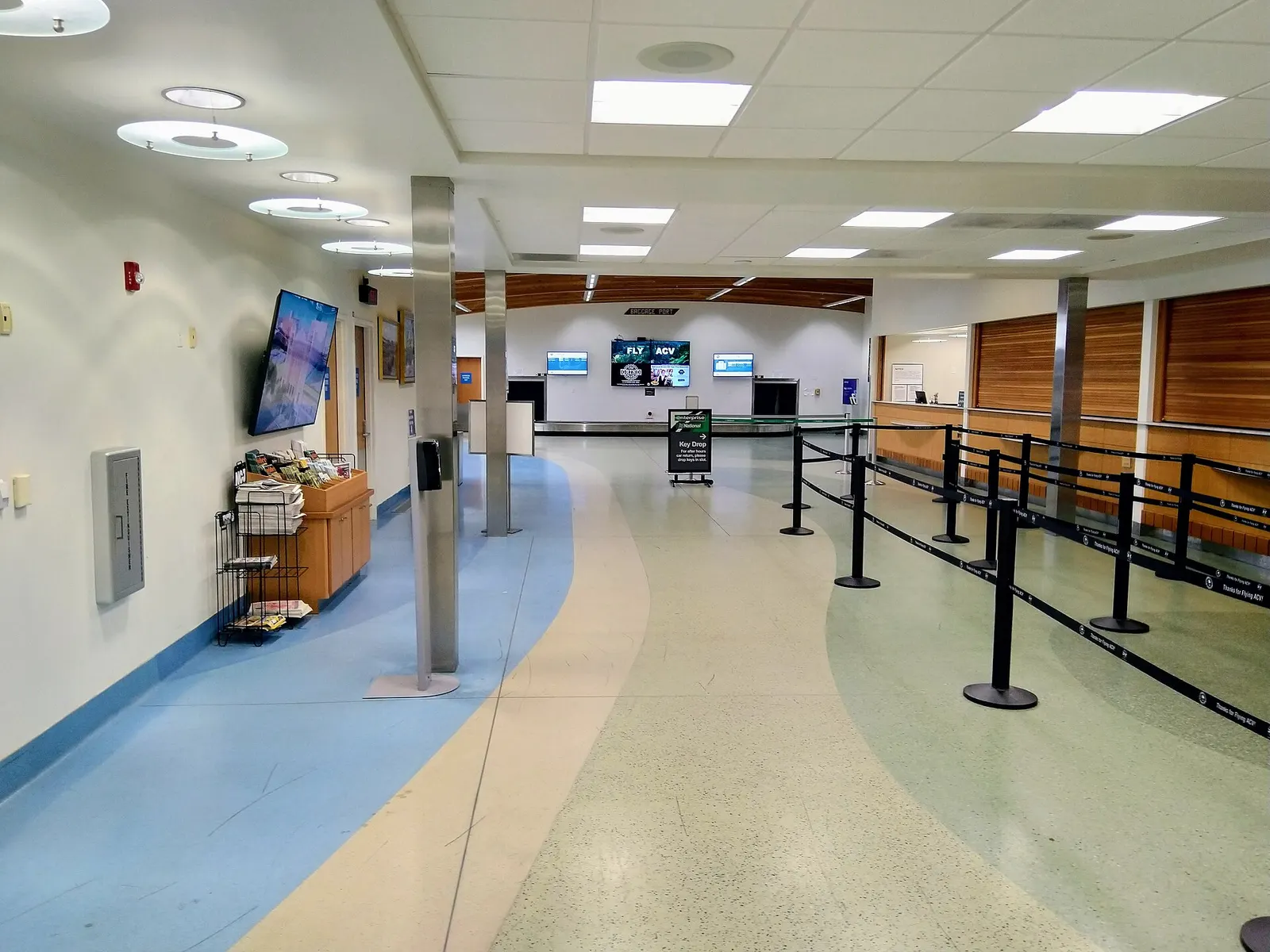 Arrivals area, information booths, and baggage claim inside the ACV passenger hall.