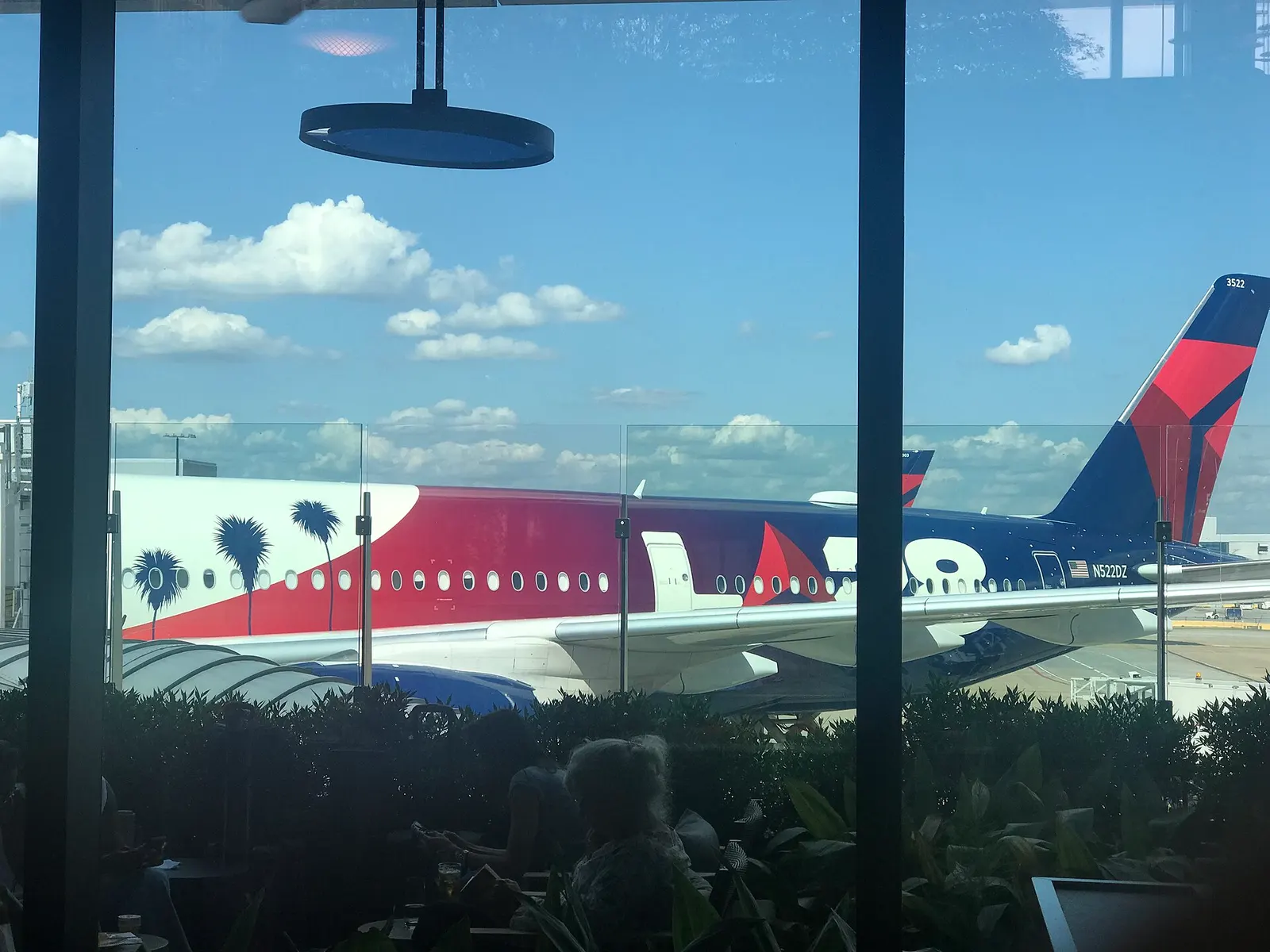 The tail of N522DZ (with its special livery) from inside the Centurion Lounge, Concourse E at Hartsfield-Jackson International Airport.