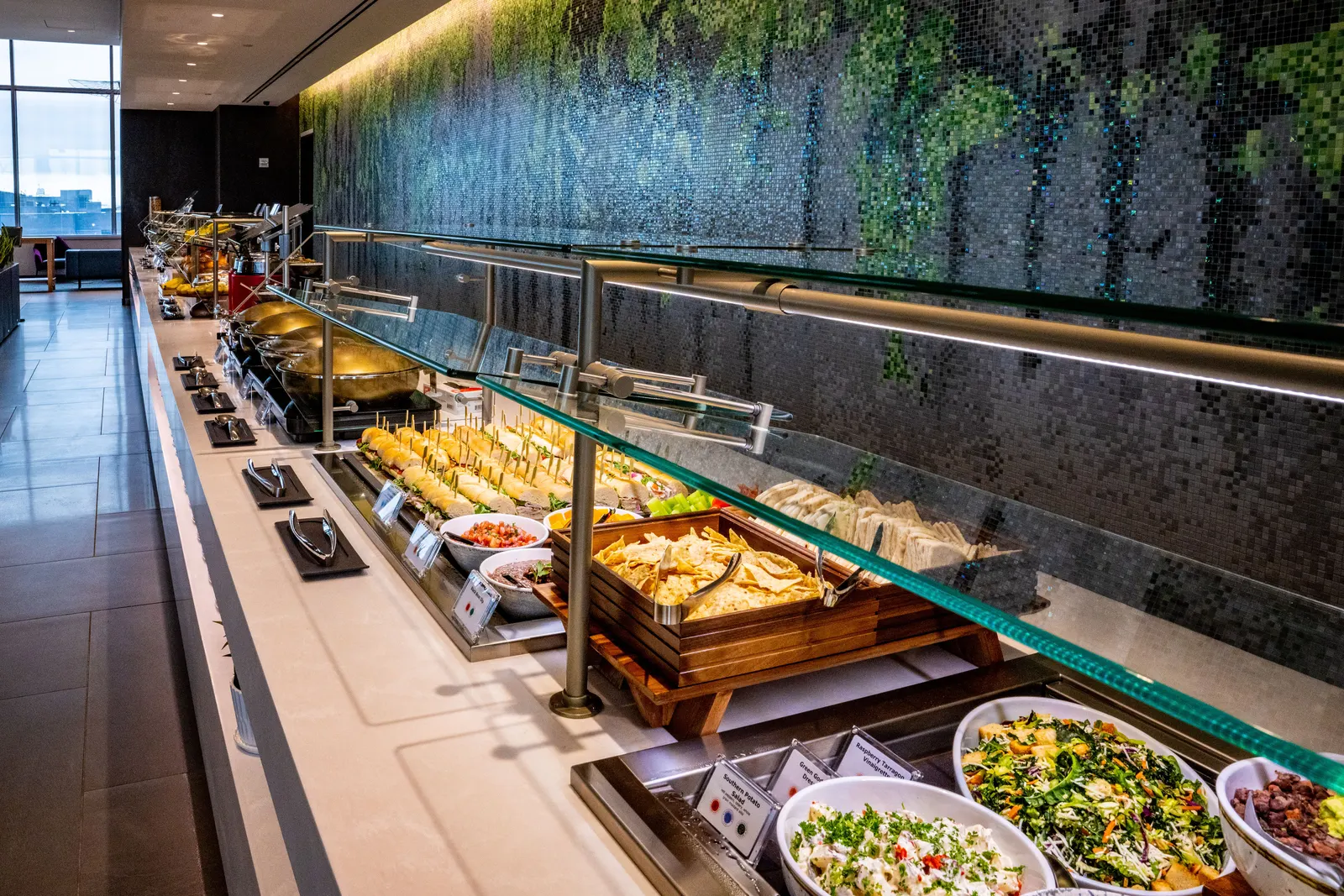 Food buffet and beverage-station area inside the Delta Sky Club in ATL Concourse D.