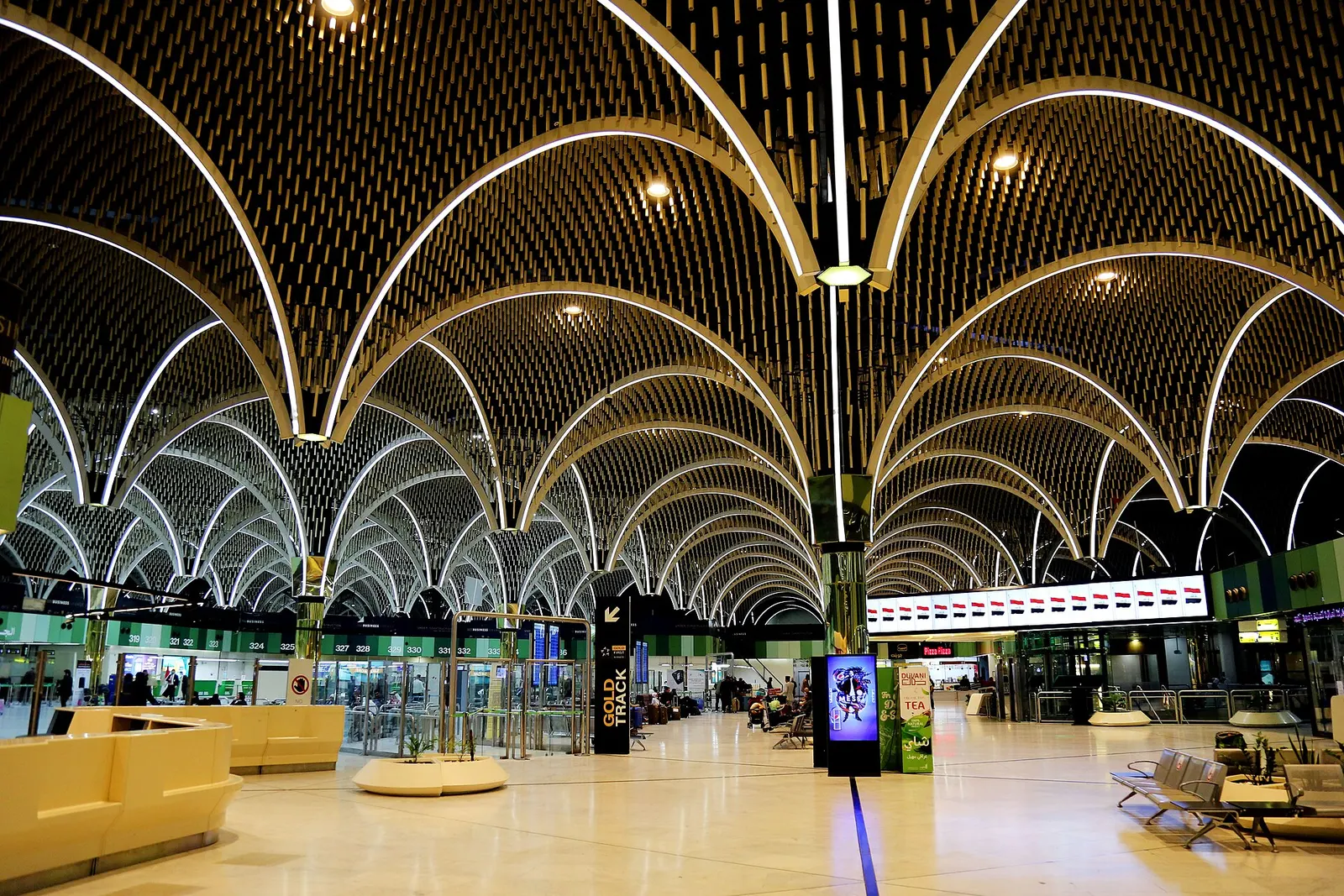 Babylon Terminal check-in hall at Baghdad International Airport, February 2022, under a vaulted ceiling of white arches