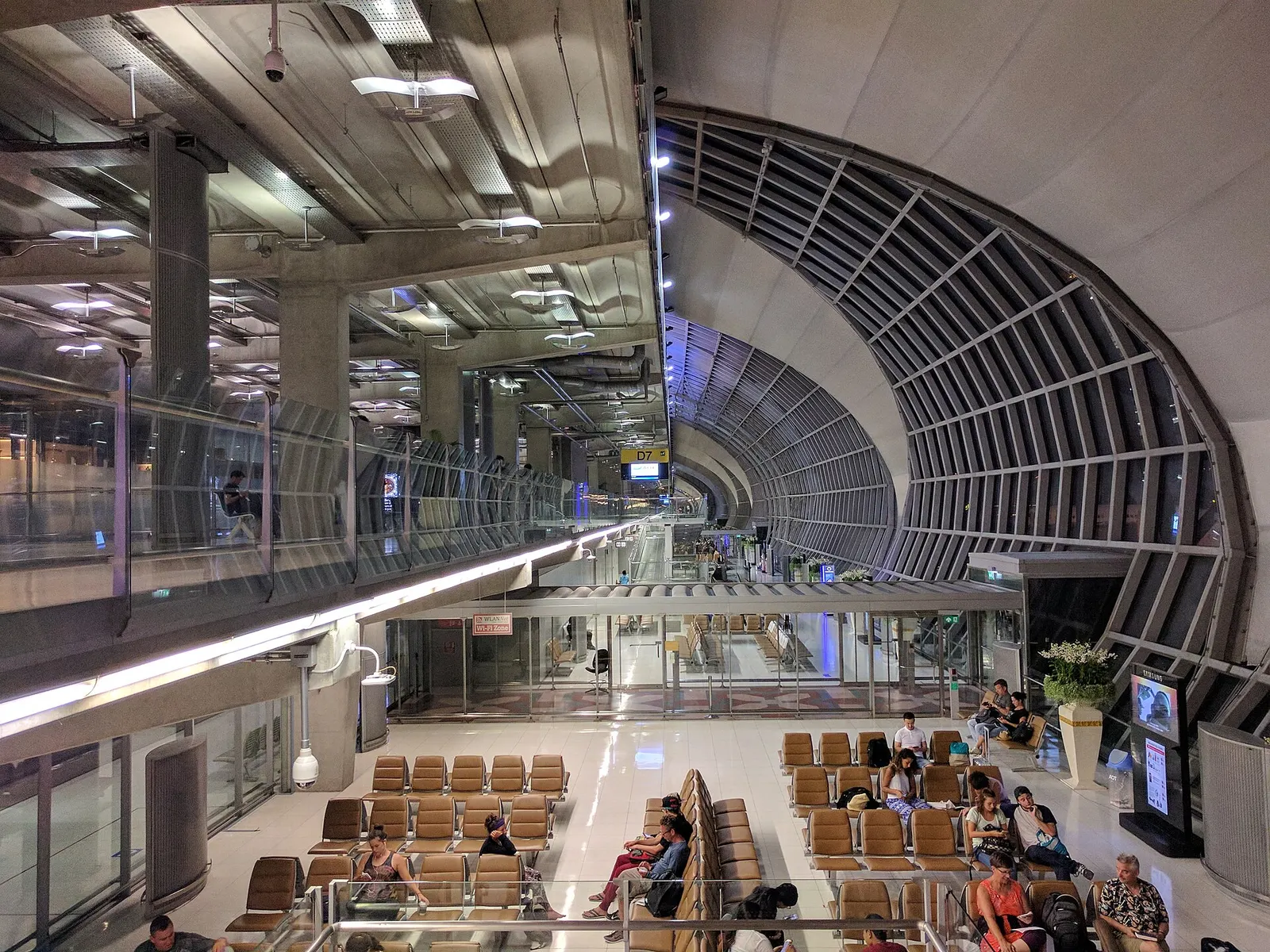 Departure waiting area in Terminal D of Suvarnabhumi Airport in Bangkok, seen from the upper level.