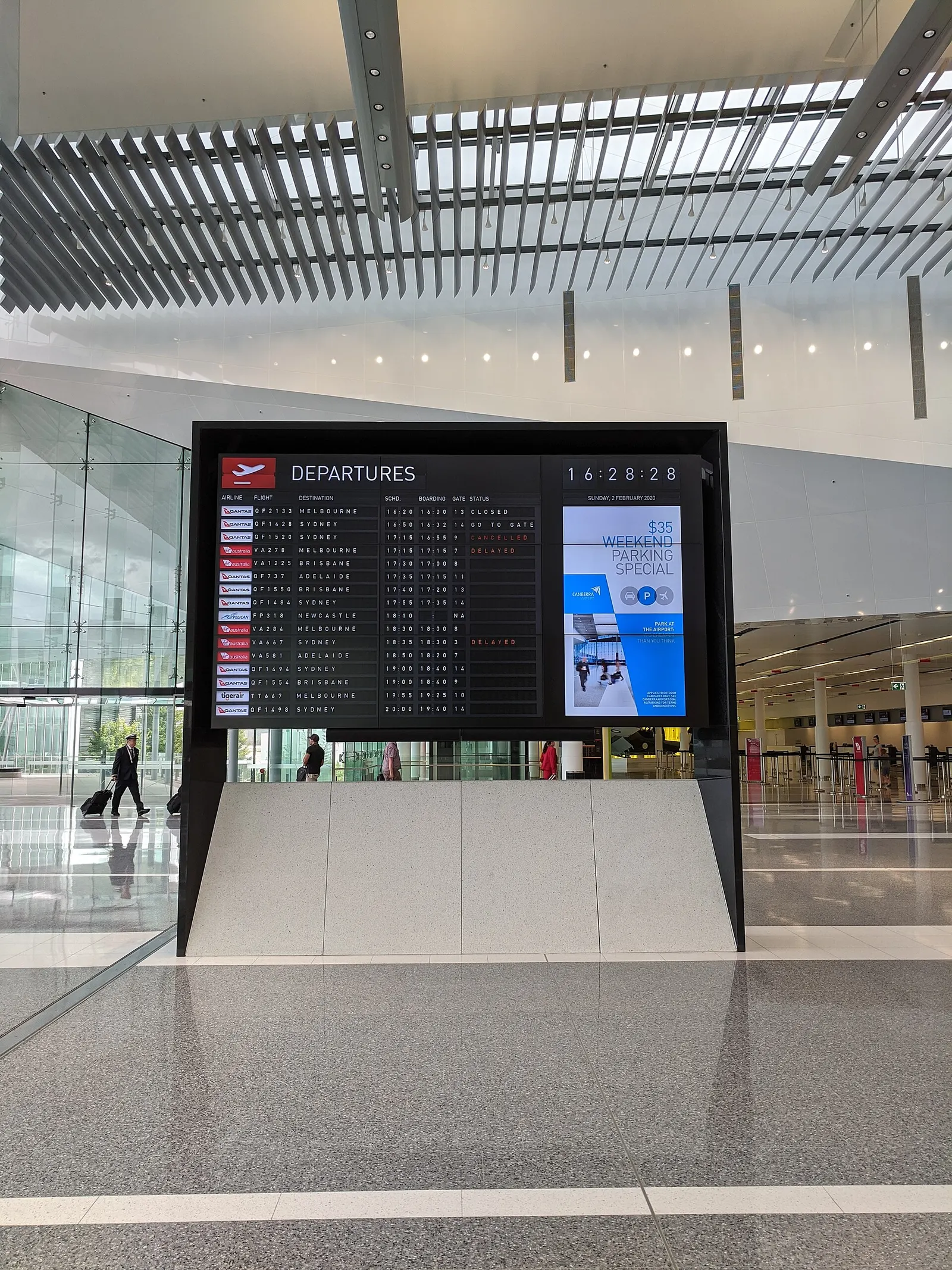 The departures board at the main entrance to Canberra Airport