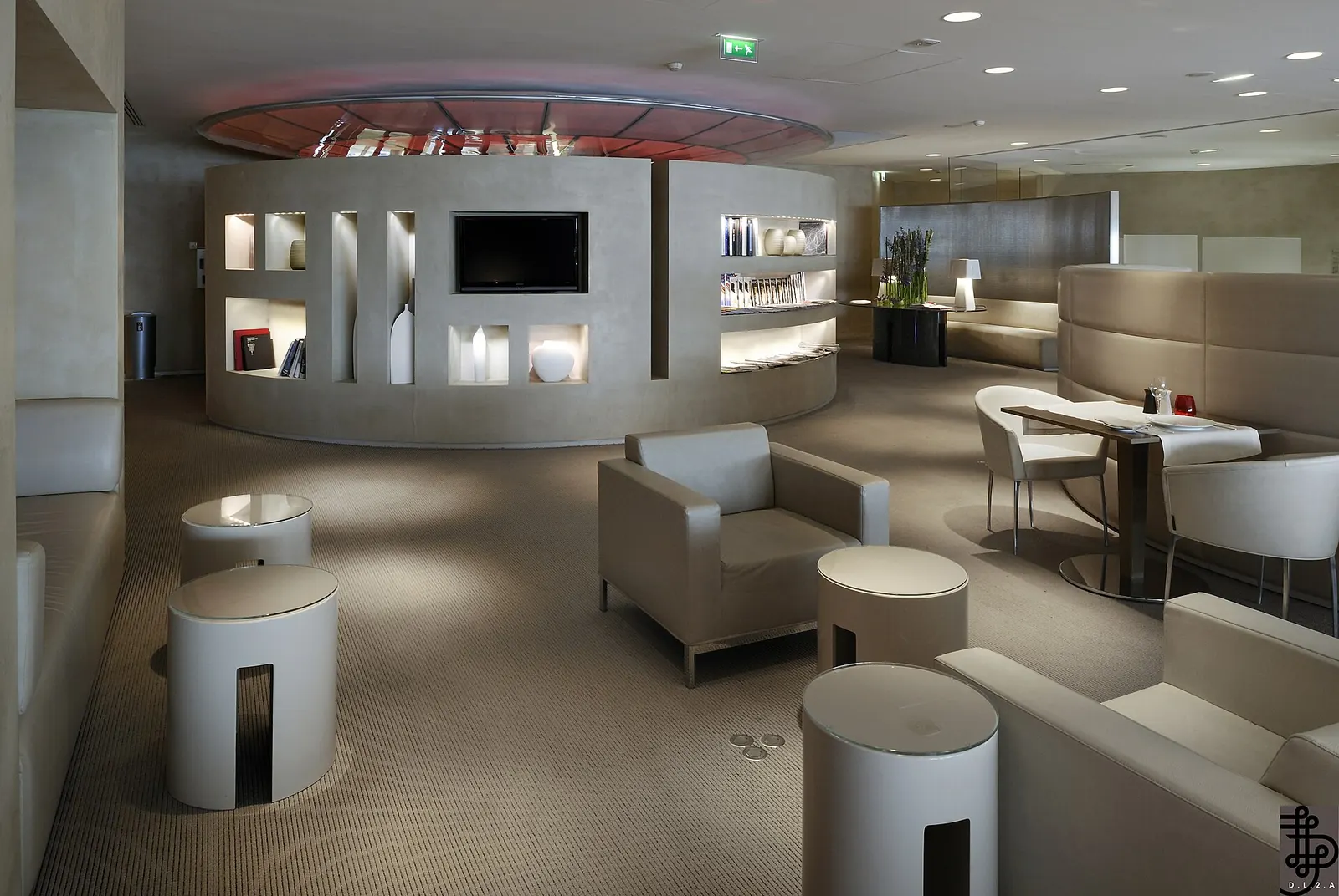 Lounge chairs and soft lighting in the Air France First Class lounge at Paris CDG Terminal 2E.