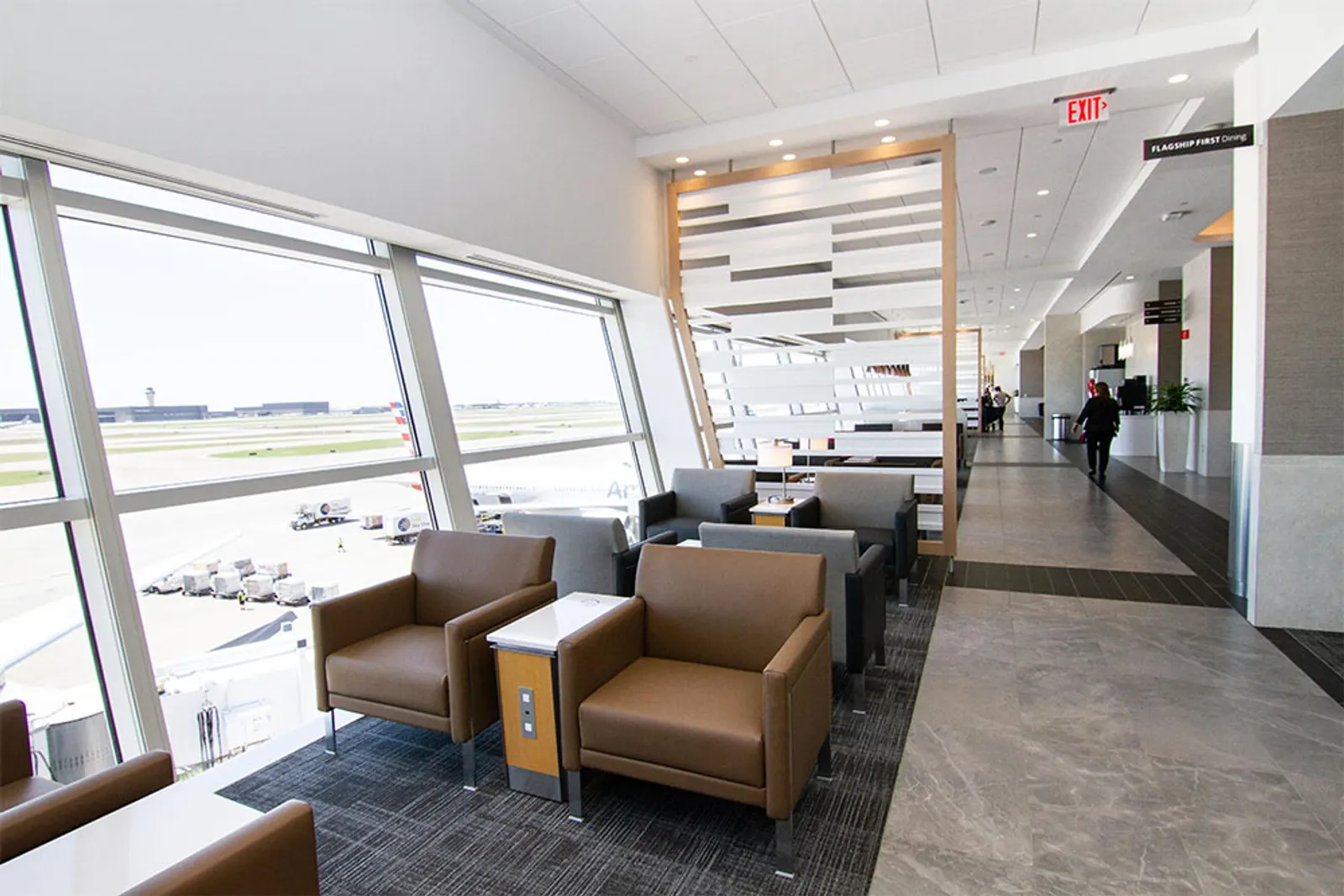 Window-side armchairs along the concourse in the American Airlines Flagship Lounge at Dallas Fort Worth International Airport (DFW).