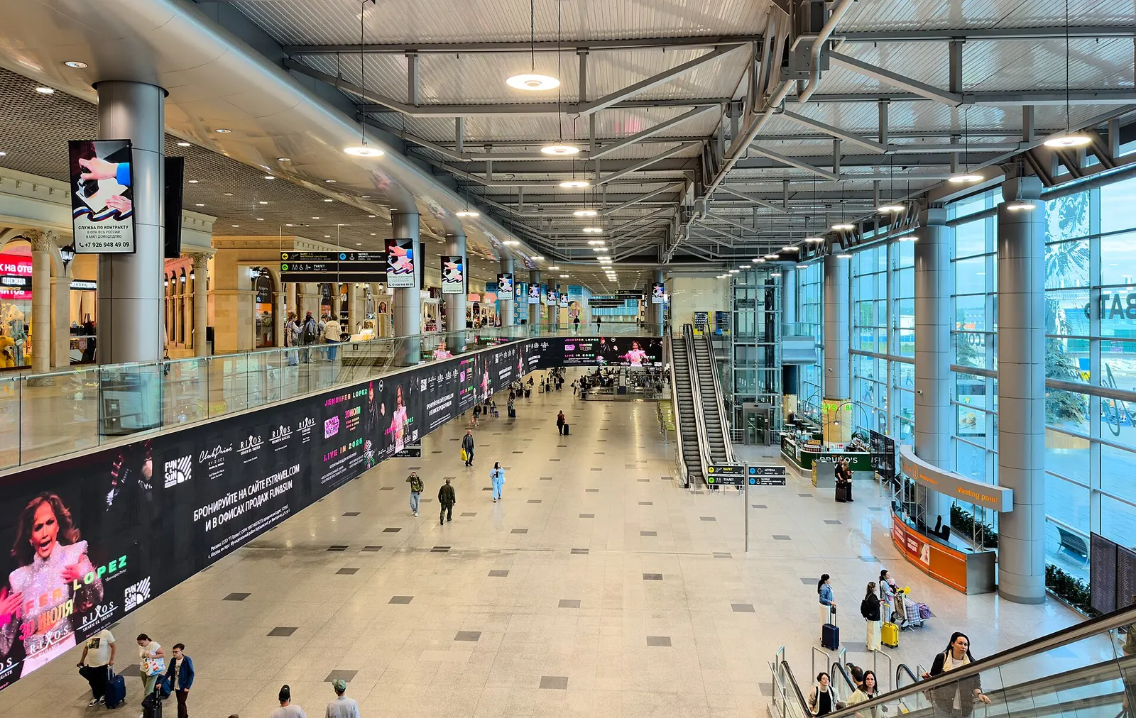 Domodedovo Terminal 2-style departure hall with FIDS screens and glass wall, July 2025