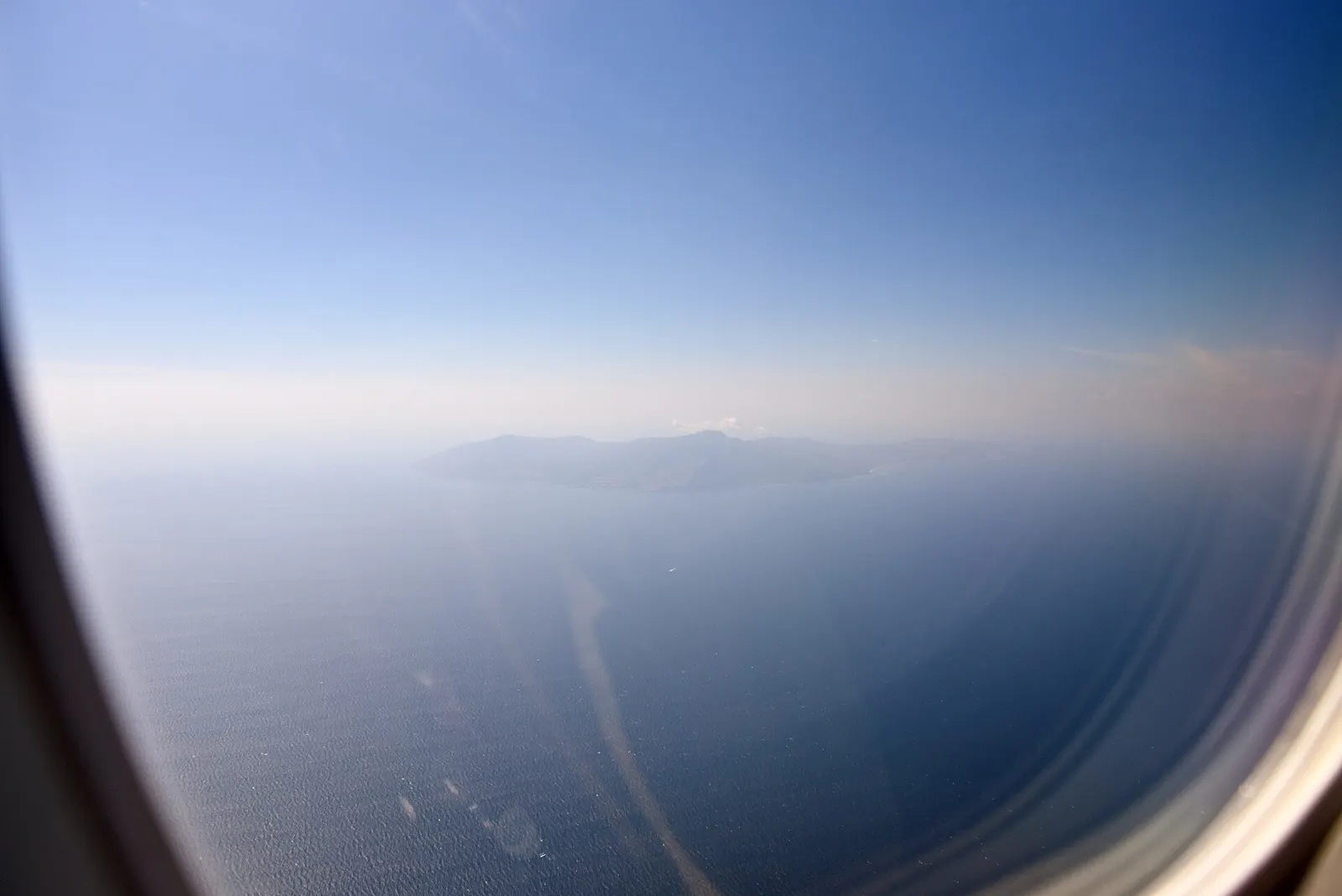 Aerial photograph of the island of Atauro , East Timor, from a port side cabin window of QantasLink 190AR VH-UZH, shortly after take off from Presidente Nicolau Lobato International Airport , Dili, East Timor, en route to Darwin International Airport (DPS/WADD), Darwin, Australia, as QF350