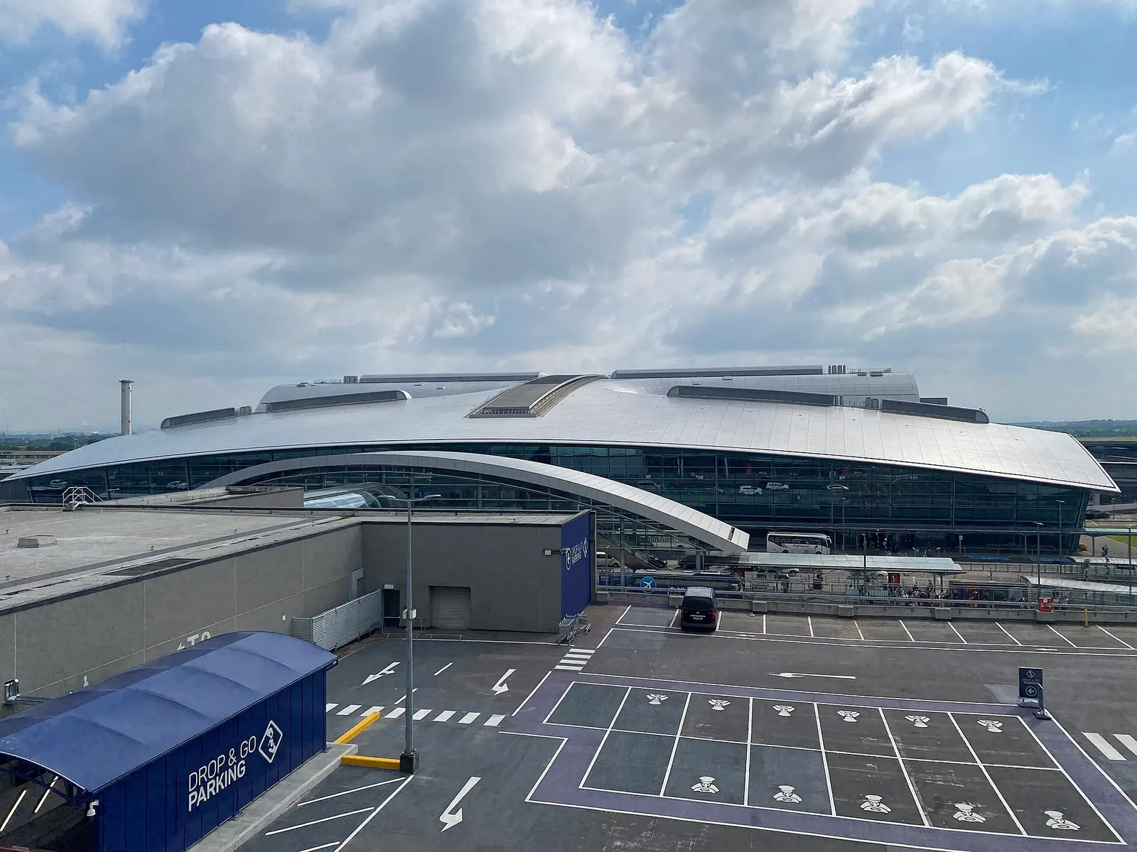 Dublin Airport Terminal 2 exterior in May 2024, showing the glass facade and forecourt.
