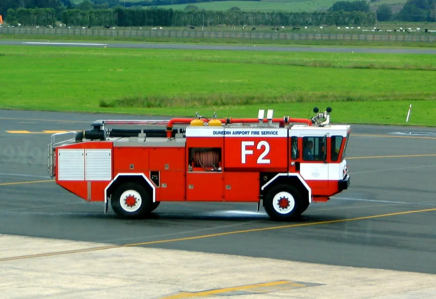 Airport crash tender on the apron at Dunedin International Airport , Dunedin, New Zealand. Taken from inside the terminal building, some slight reflection