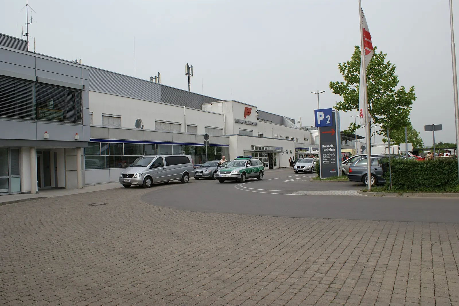 Landside kerb at Bodensee-Airport Friedrichshafen with the P2 short-stay sign and the compact terminal entrance.