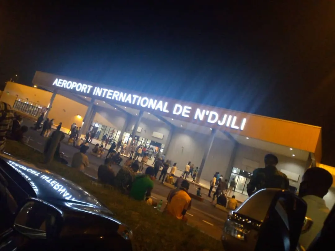 Night landside façade of N'djili International Airport with AEROPORT INTERNATIONAL DE N'DJILI lettering, August 2023.