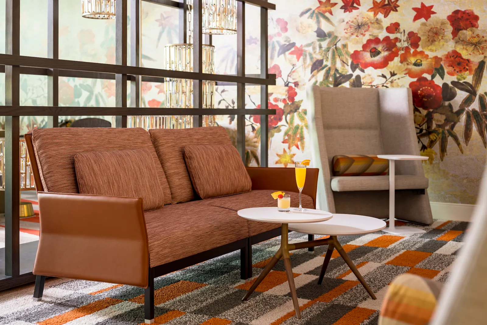 Wide seating overview with lime-green chairs and floral mural in the Escape Lounges at Fort Lauderdale (FLL).