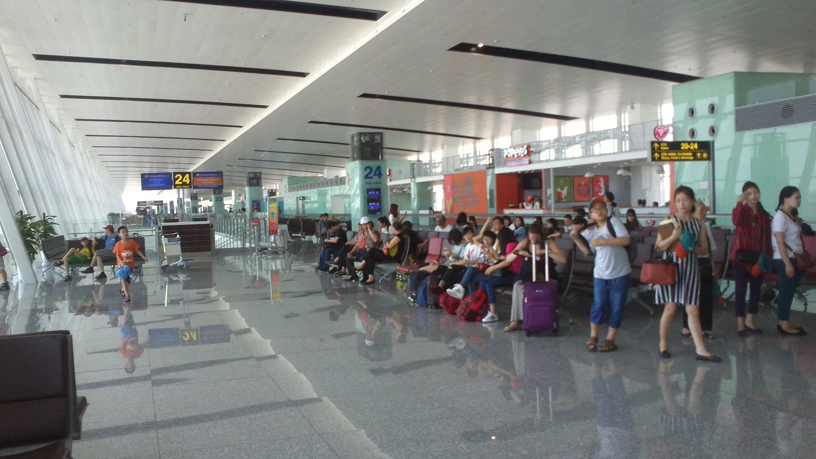 Waiting area of Terminal 2 at Noi Bai International Airport, with rows of seats under a high roof.