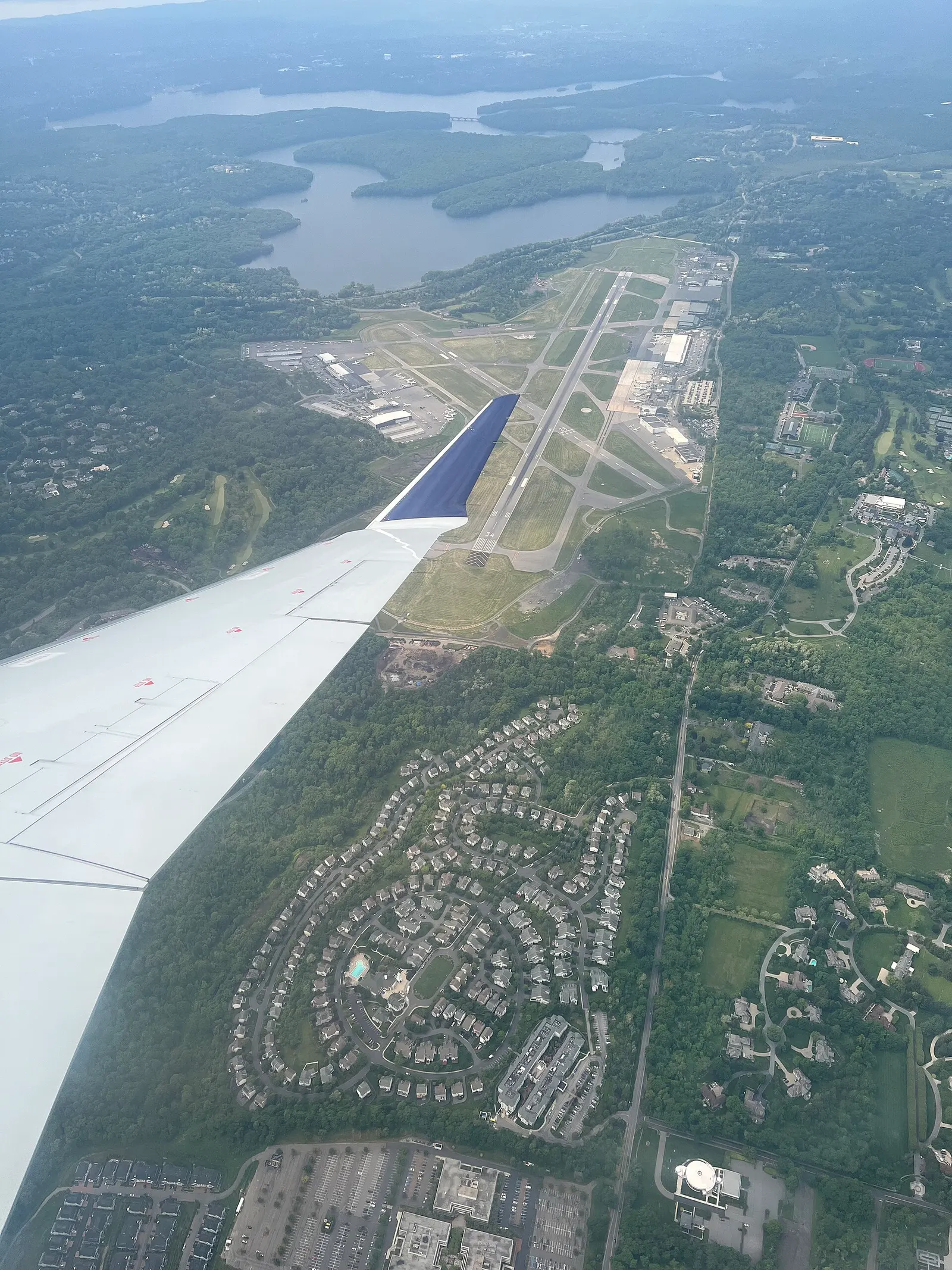 May 2023 aerial of Westchester County Airport near White Plains, showing the civil terminal and the two-runway field.