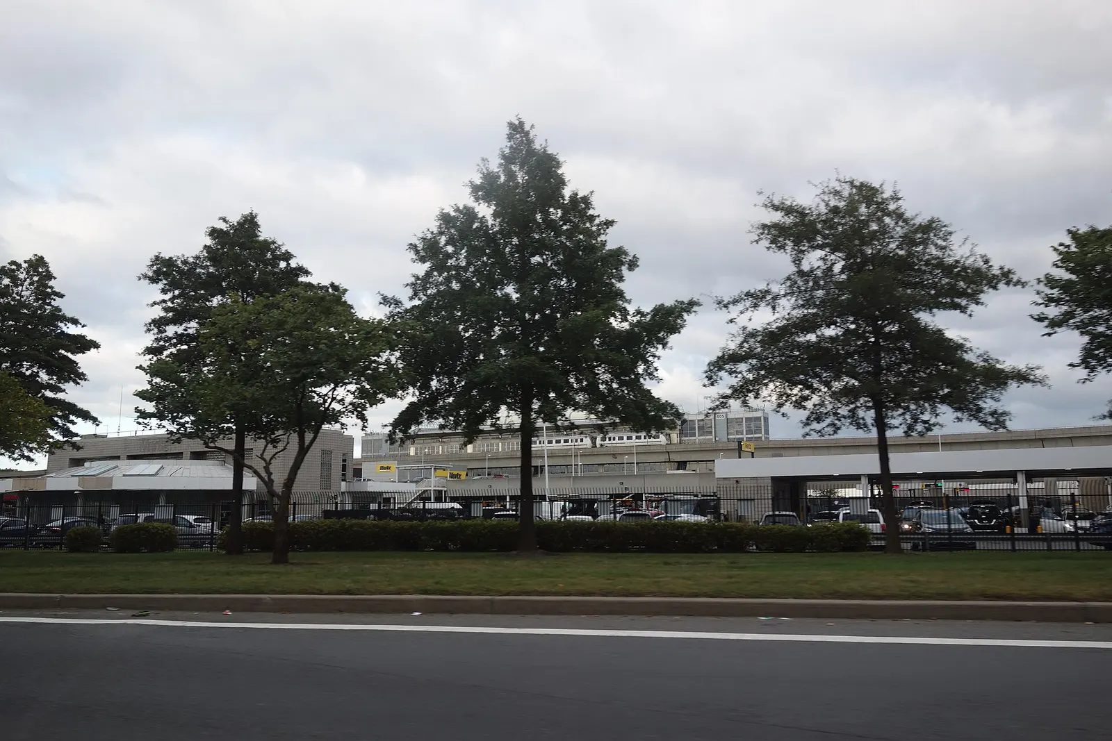 Traveling counterclockwise around the Federal Circle roundabout in John F. Kennedy International Airport, at the Van Wyck Expressway near South Ozone Park, Queens. Pictured is the AirTrain station in the distance to the east.