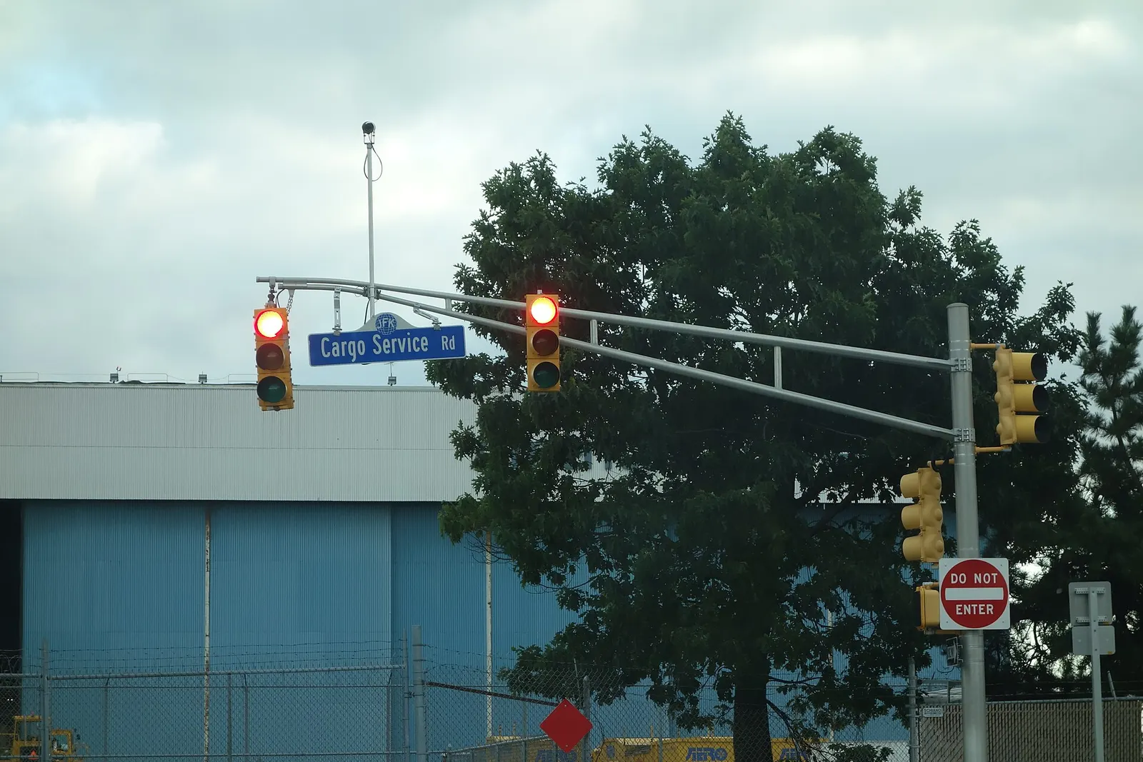 Traffic lights and street signs in front of American Airlines Hangar 10 across from the Federal Circle AirTrain station at the north end of John F. Kennedy International Airport, on Cargo Service Road east of Federal Circle near South Ozone Park, Queens.