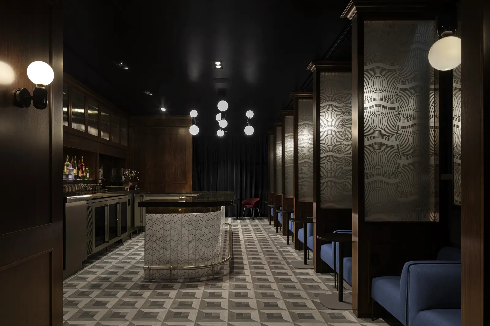 Speakeasy-style cocktail bar seating in The Centurion Lounge at New York JFK Terminal 4.