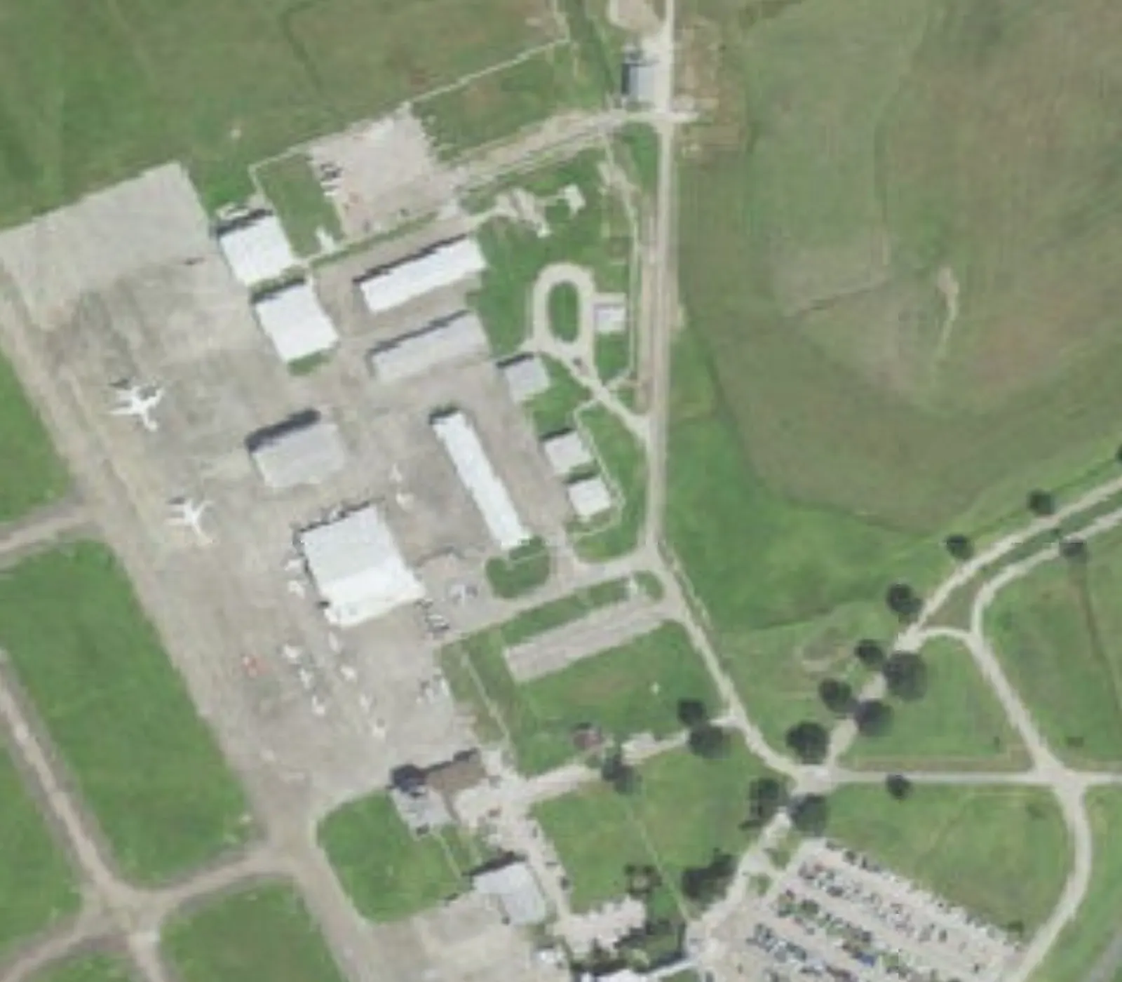 Closer aerial of the LCH passenger terminal, public parking lot, and east-side apron.