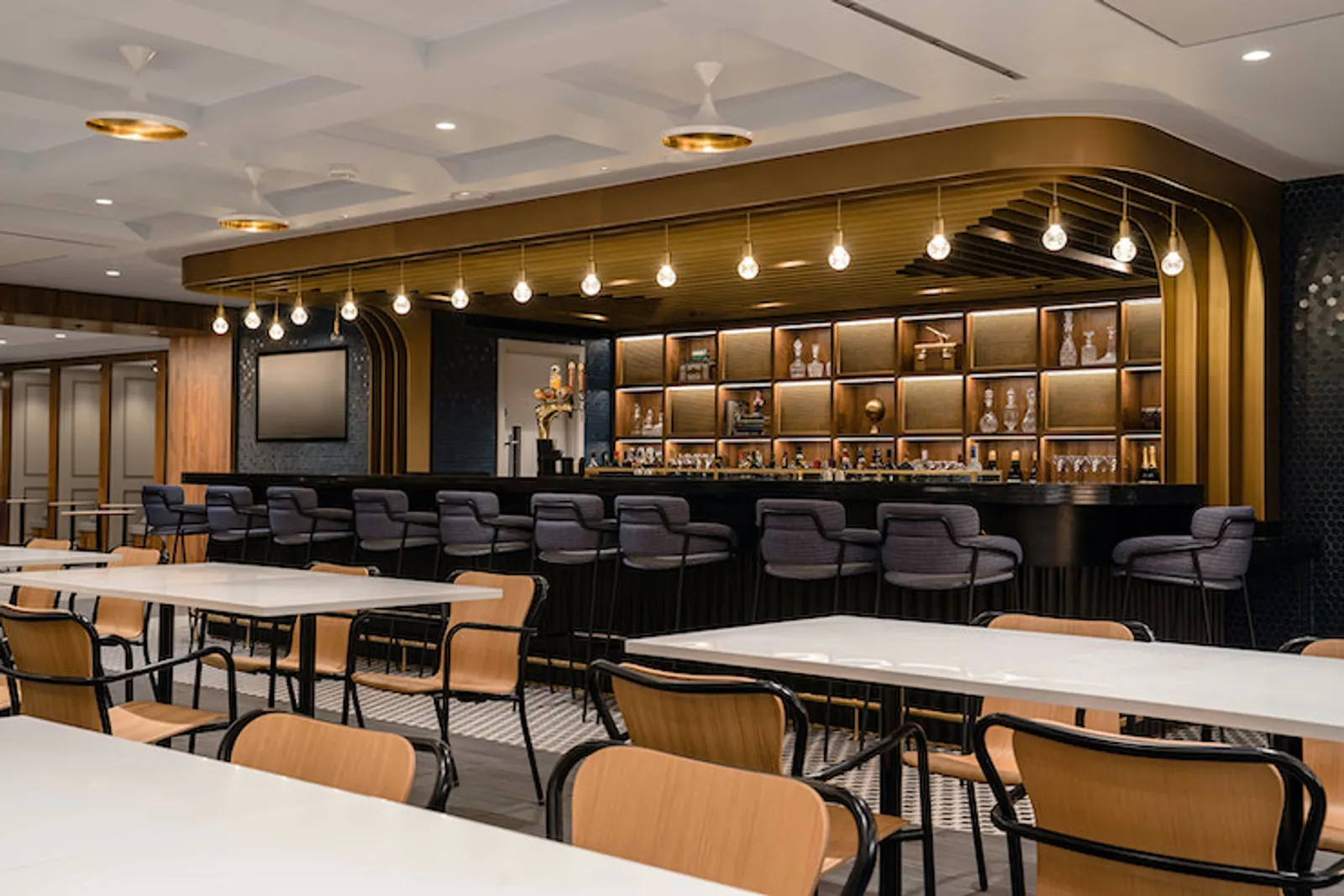 Dining area with tables and chairs in the Centurion Lounge at London Heathrow Terminal 3 (LHR).