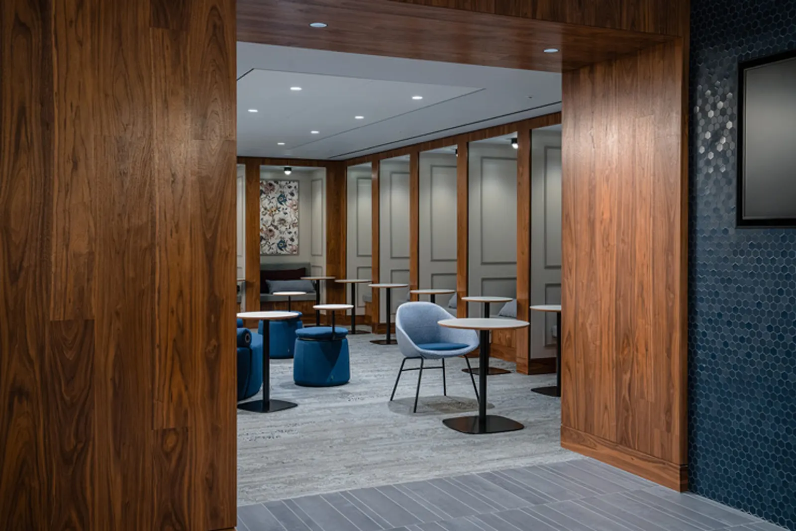 Seating area with tables and chairs in the Centurion Lounge at London Heathrow Terminal 3 (LHR).