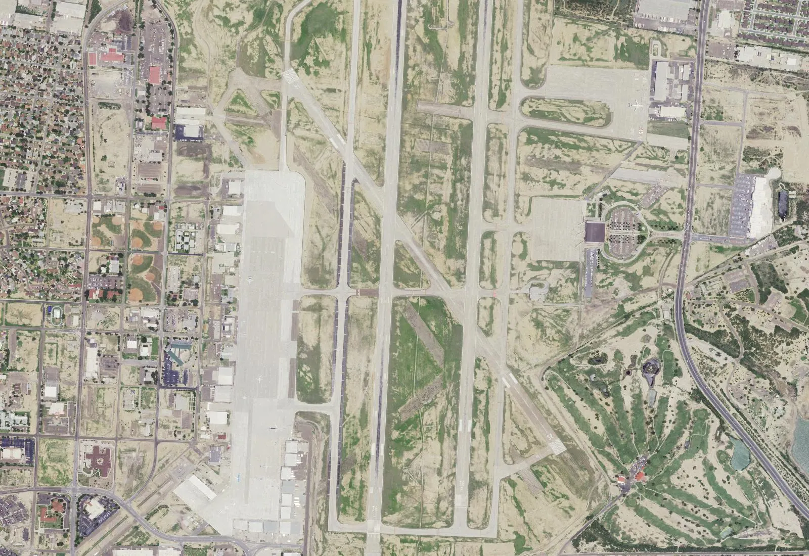 Closer USGS NAIP crop of Laredo International Airport parallel runways, west cargo apron, and east passenger-terminal loop.