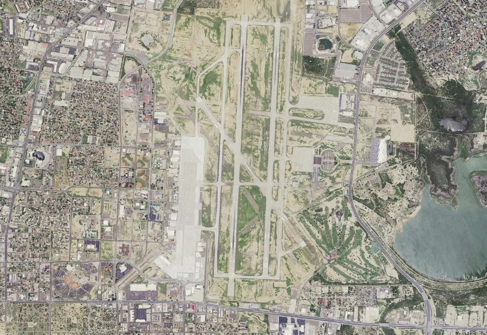 USGS NAIP aerial of Laredo International Airport showing the parallel 18/36 runways, diagonal 14/32, cargo aprons, and the east-side passenger terminal.