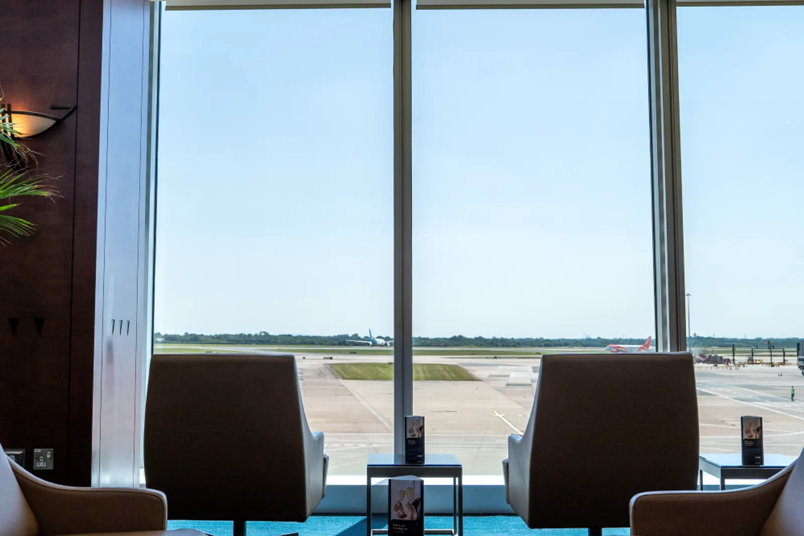 Lounge seating facing floor-to-ceiling windows in the Escape Lounge at Manchester Terminal 3 (MAN).