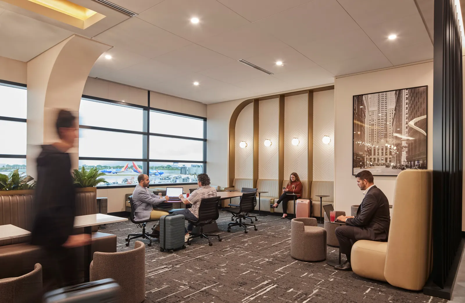 Lounge overview with runway-facing windows in The Club Central Market at Chicago Midway (MDW).