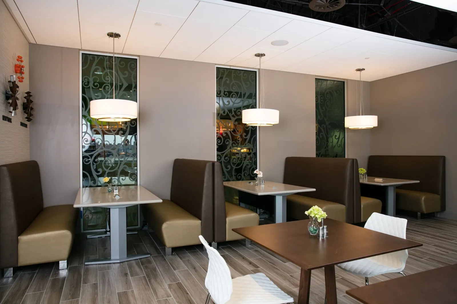 Booth and table seating in the Escape Lounge at Oakland International Airport (OAK).