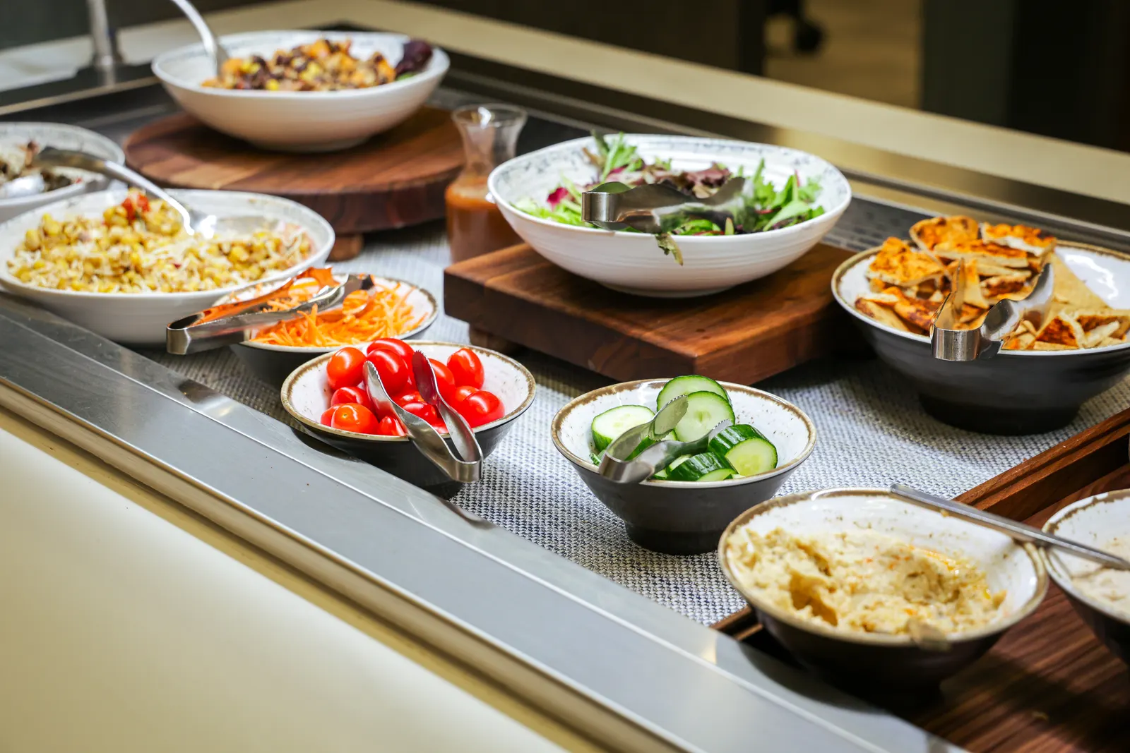 Self-serve cold salad buffet with hummus and pita in the renovated Delta Sky Club at Philadelphia (PHL).