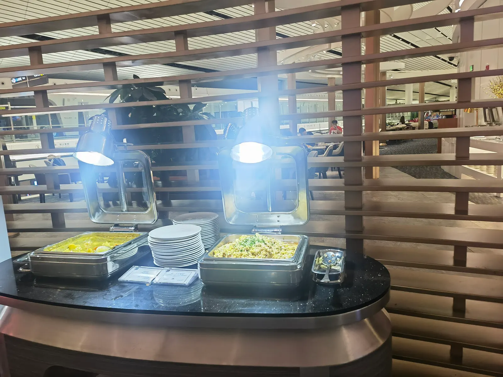 Food service area inside the CHUM VIP Lounge at Beijing Daxing International Airport.