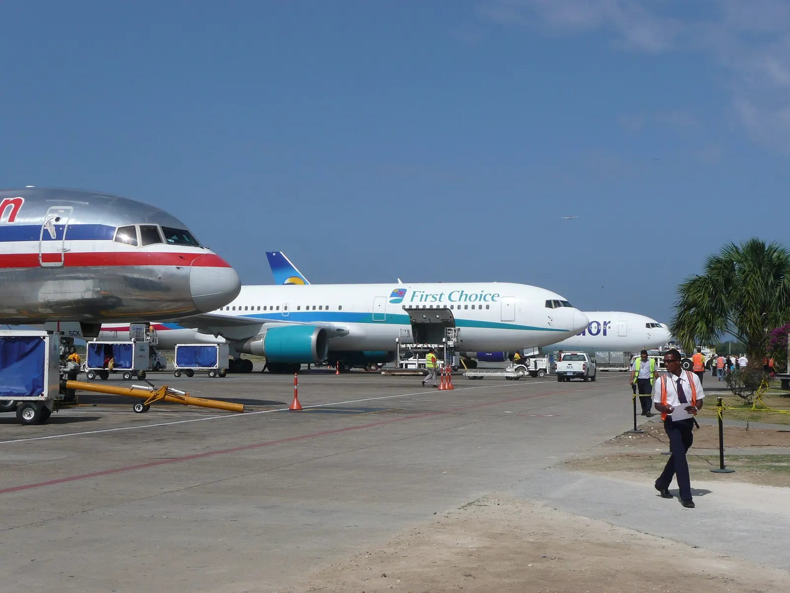 View of aircraft parked at several gates adjacent to Terminal One at Punta Cana International Airport , Dominican Republic .
