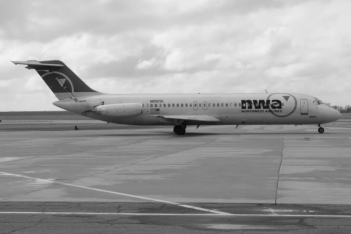 Historic Northwest Airlines DC-9-31 taxiing toward runway 13 at Rochester International Airport, photographed from the observation area.