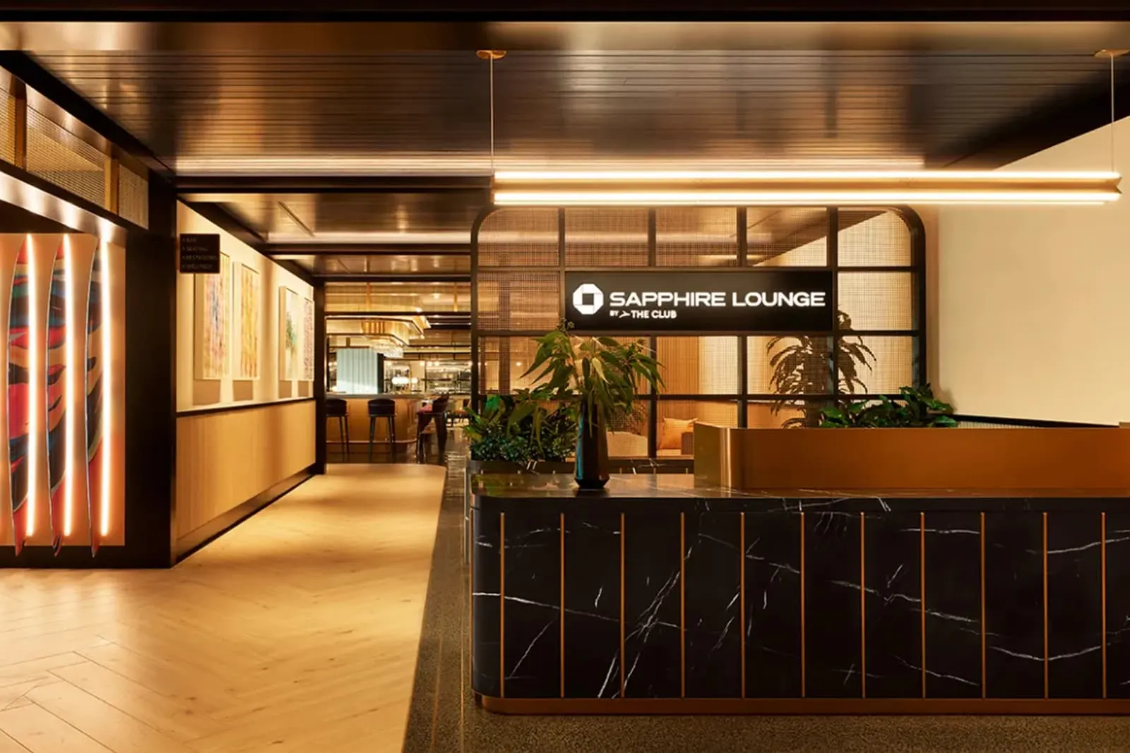 Reception desk and Sapphire Lounge by The Club backlit sign at San Diego International Airport (SAN).