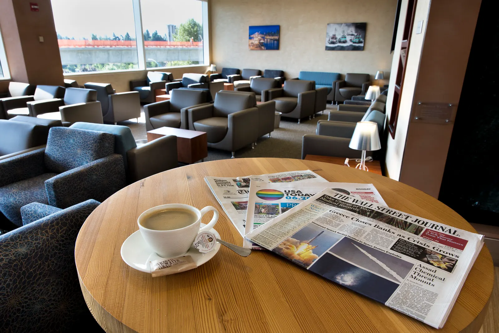 Interior gallery view of The Club at SEA Concourse A with contemporary lounge furnishings.