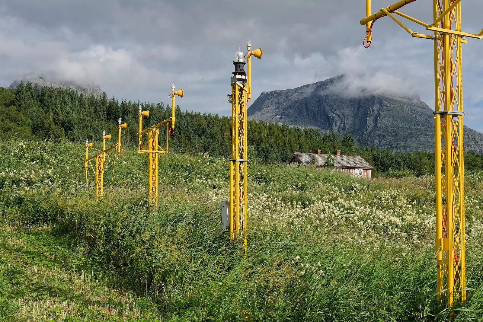 Approach lights at Sandnessjøen Airport, Nordland, Norway. In the background the southwestern end of the Sju søstre mountain range is visible.