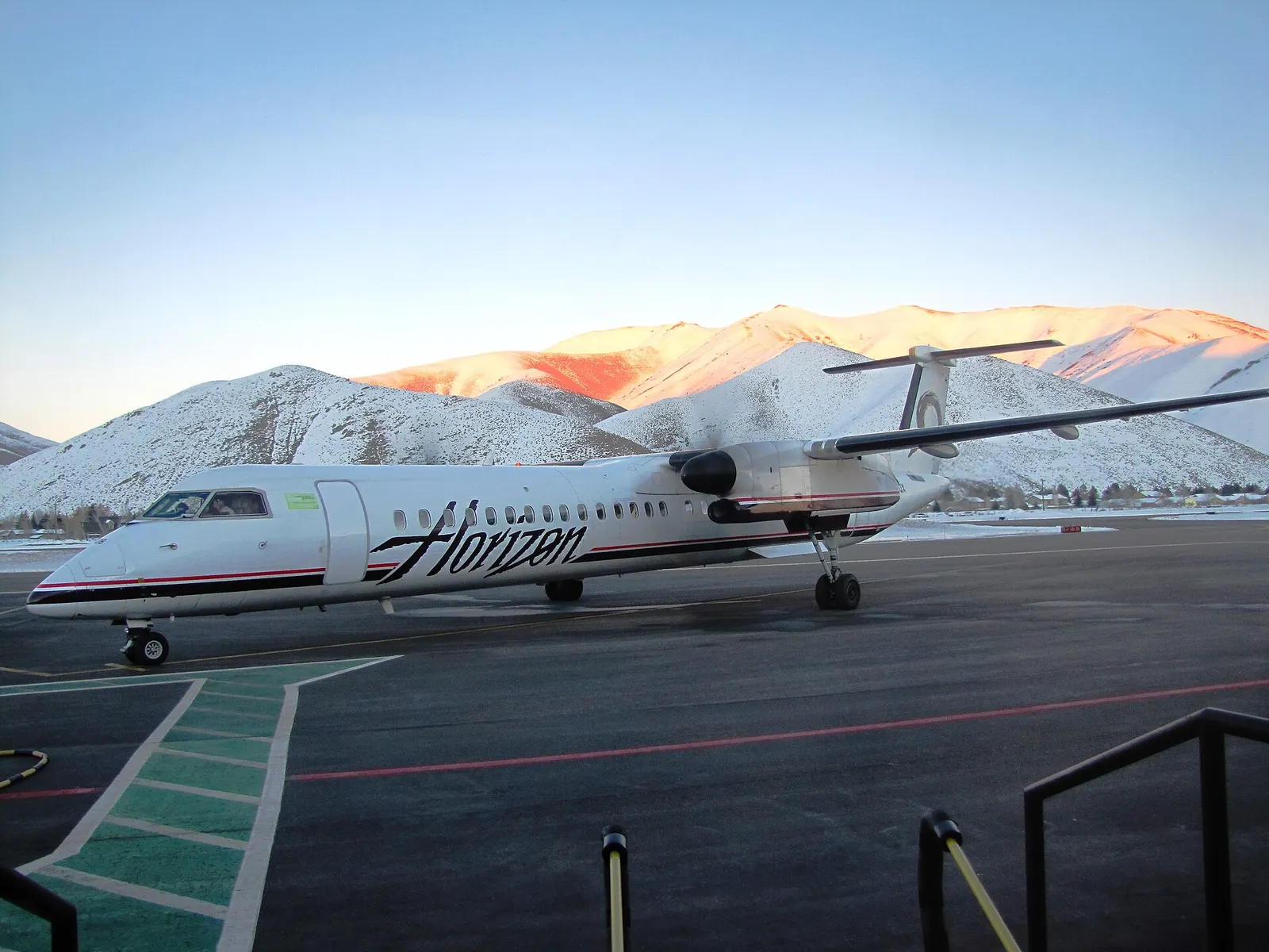 Horizon Air Dash 8 Q400 N408QX on the Friedman Memorial apron in Hailey, with snow-covered Pioneer Mountains behind the field, photographed in 2012.