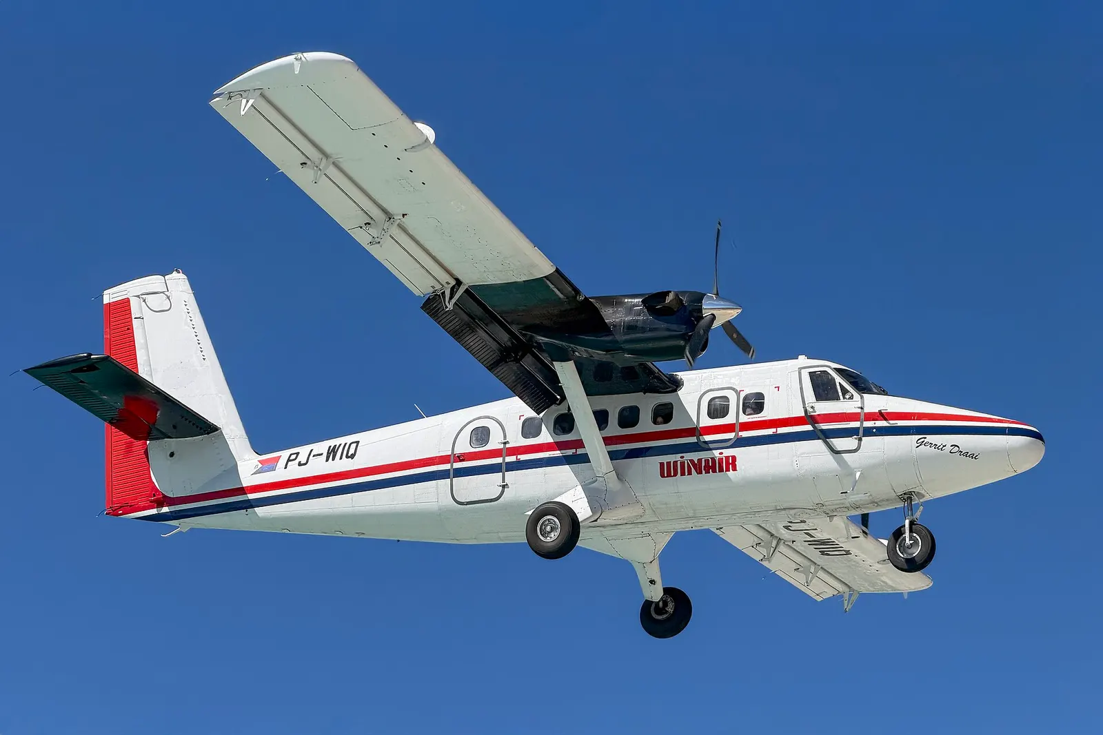 A Winair DHC-6 Twin Otter landing at Princess Juliana International Airport in the Caribbean island of Sint Maartin on December 2, 2025.