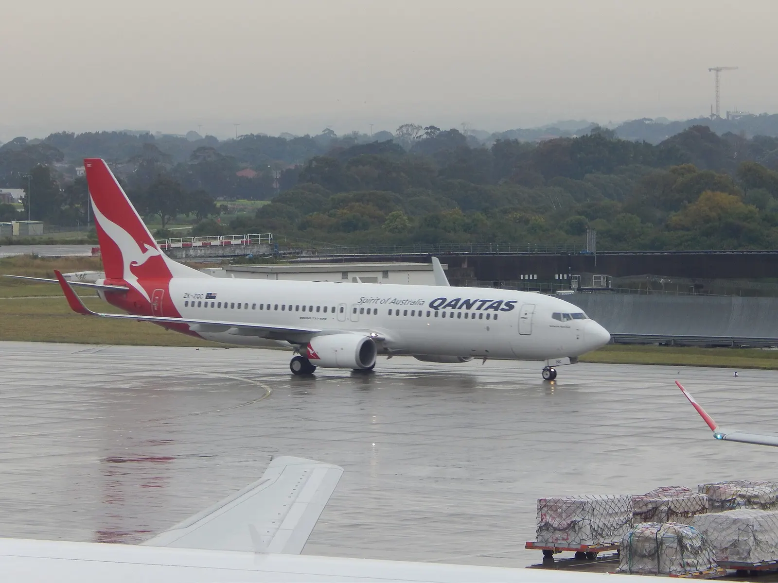 Qantas Jetconnect Boeing 737-800 on the apron, photographed from the Air New Zealand Koru Lounge.