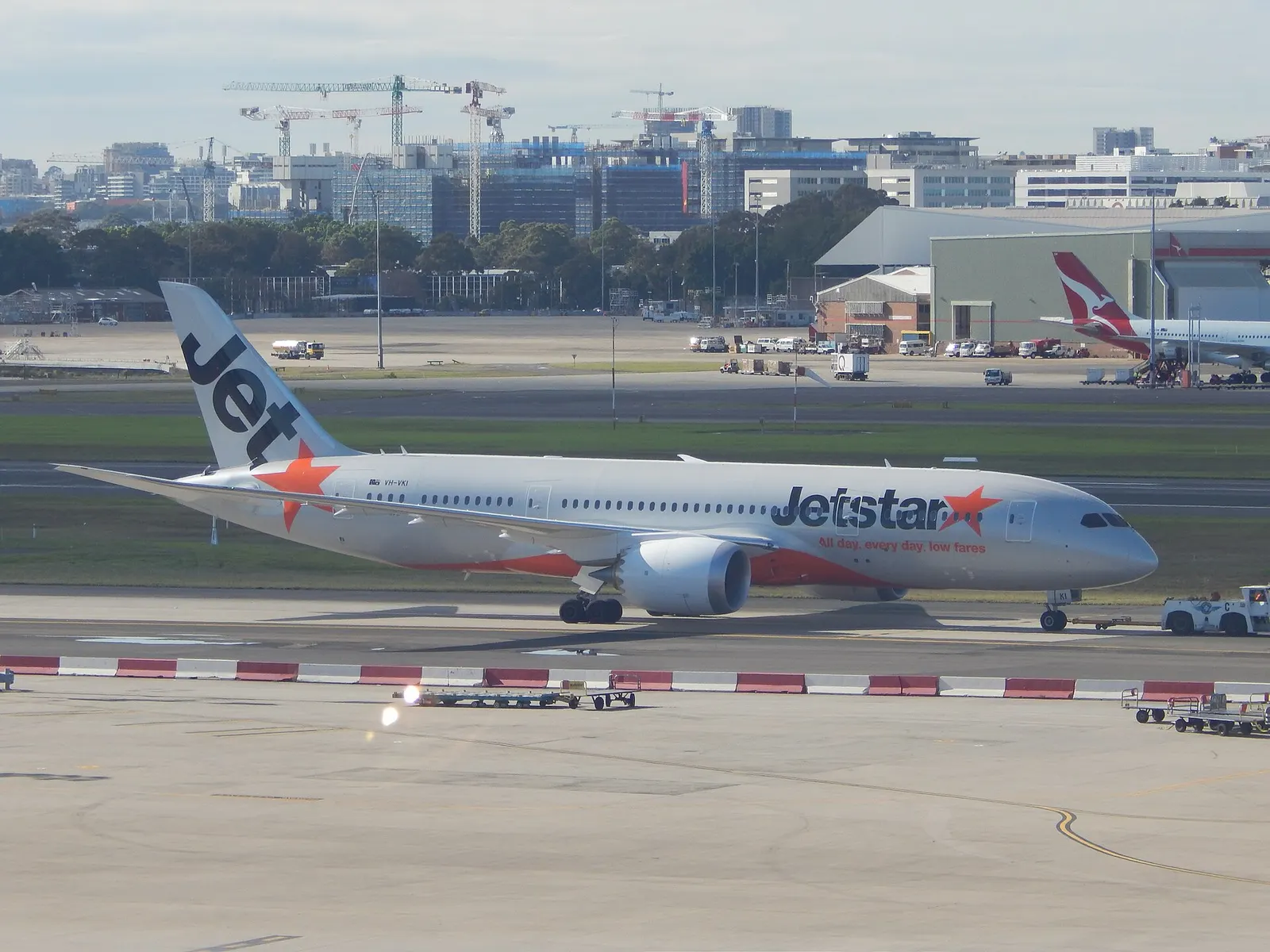 Jetstar Boeing 787 being towed onto its stand at Sydney Airport, viewed from the Qantas First Lounge.