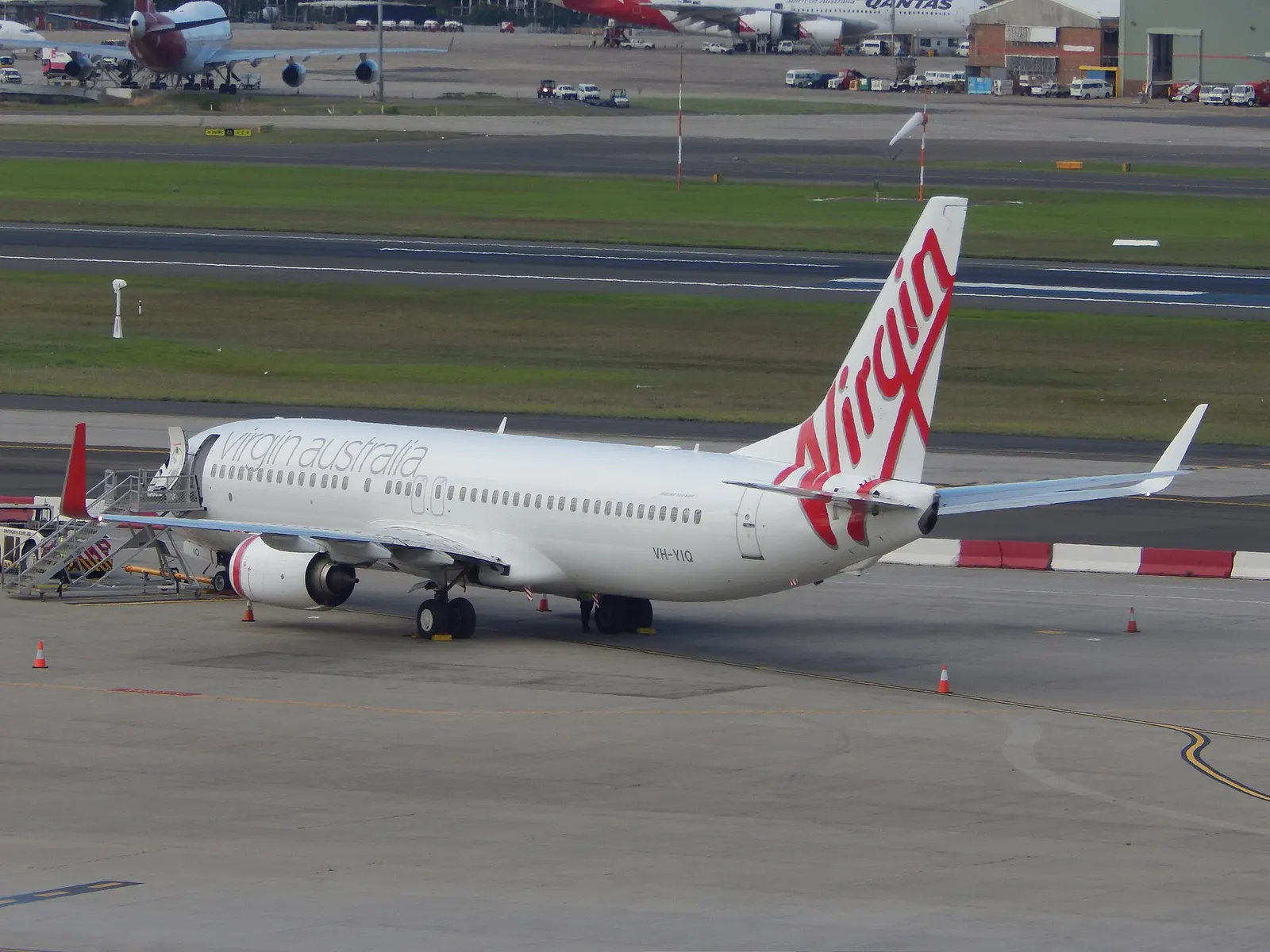 Virgin Australia Boeing 737 parked on a remote stand at Sydney Airport, viewed from the Qantas First Lounge.