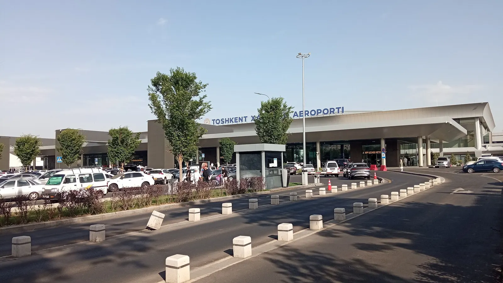 Terminal 2 curb at Islam Karimov Tashkent International Airport with the TOSHKENT XALQARO AEROPORTI letters over the canopy