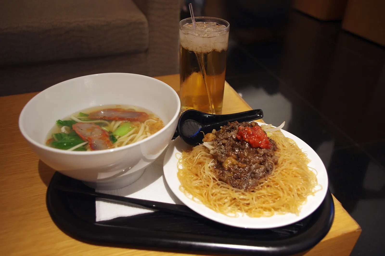 Taiwanese noodle dishes and a glass of white wine served in the Cathay Pacific Business Class Lounge.