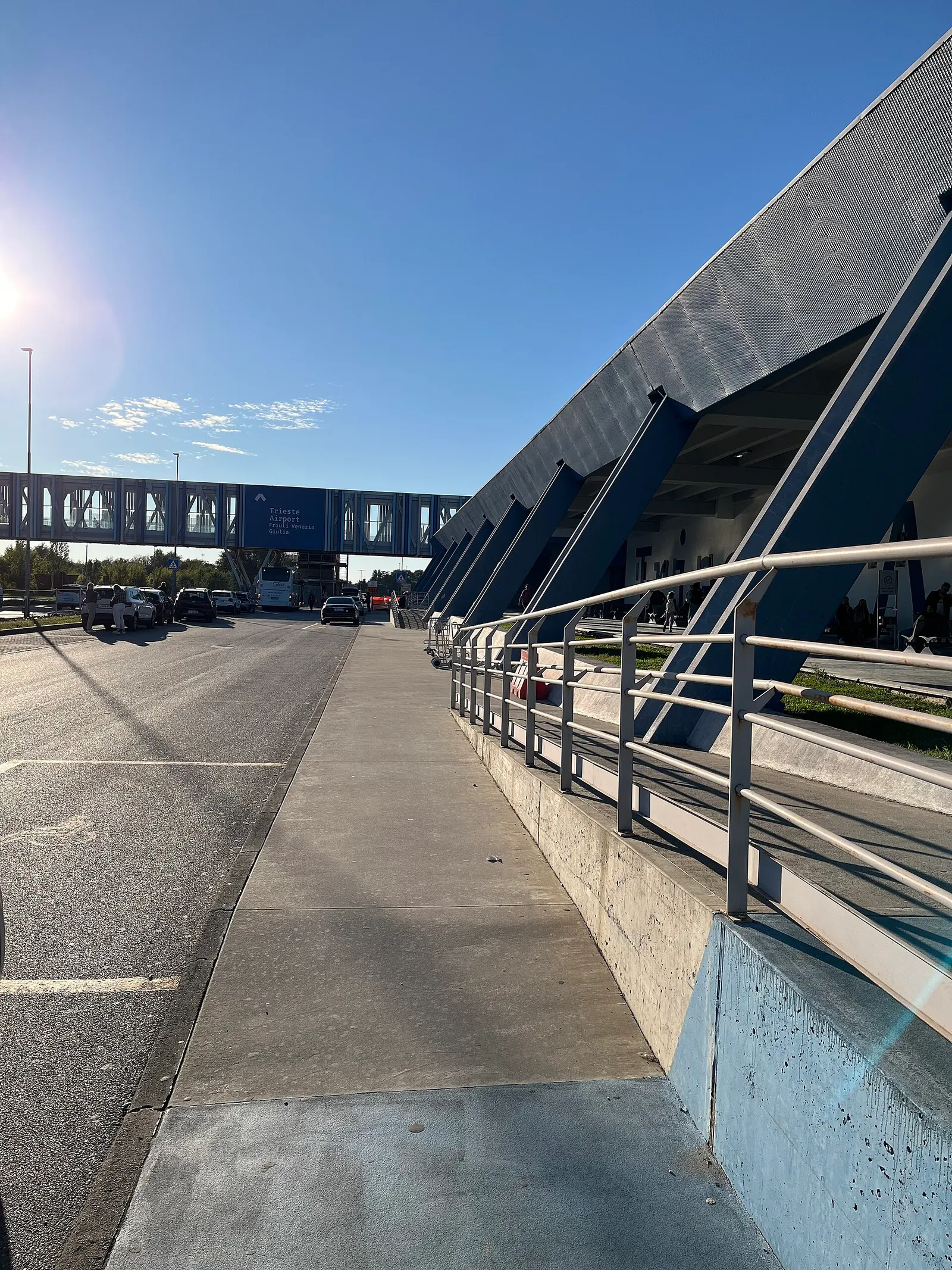 Trieste Airport terminal exterior and the covered walkway toward the railway station