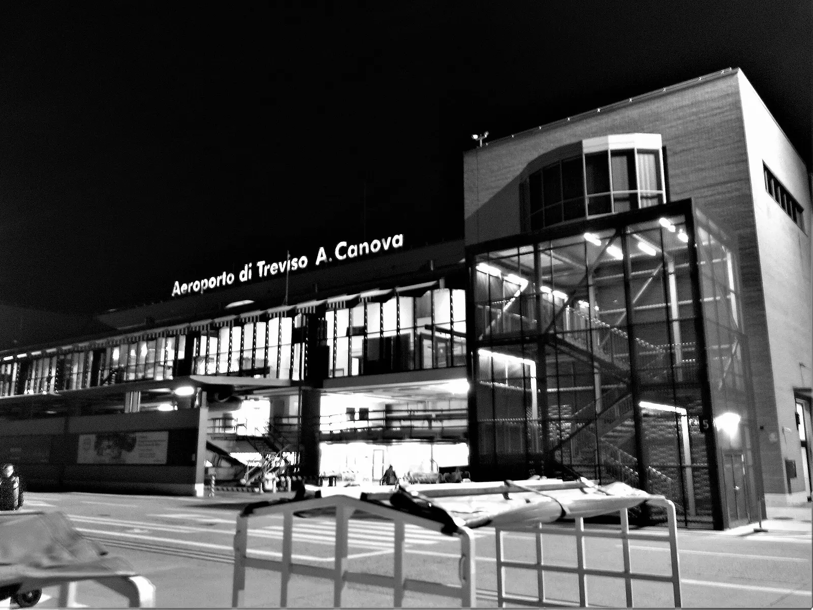 Night view of Treviso Airport buildings and apron lighting.