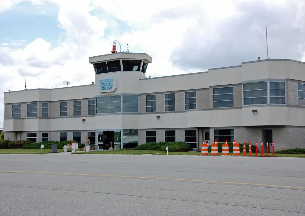 2009 general-aviation terminal and tower at Concord Regional Airport, the FBO campus, not the later Zephyr Place commercial hall.