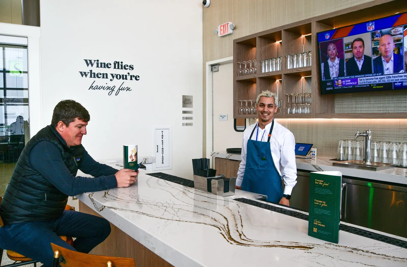 Bar counter and bartender in the Escape Lounge at Northwest Arkansas National Airport (XNA).